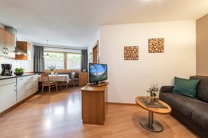 A modern apartment with a kitchen, dining area, and living room.