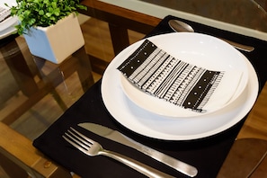 A plate with a black and white patterned design, a fork, and a spoon on a black placemat. - 1 Minute From Ipanema Beach Vsc3 (Rio de Janeiro)