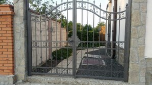 A wrought iron gate with intricate designs, leading to a paved pathway. - Inviting 1-bed Apartment in Aleksandrovo (Pomorie)