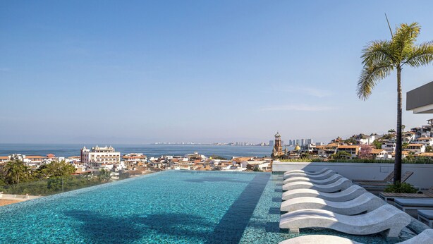 A infinity pool with a view of the sea and cityscape. - CASA|AZUR – Distinctive Style with A View (Puerto Vallarta)
