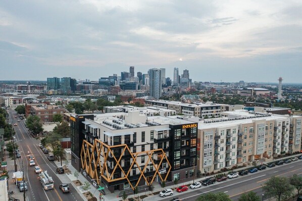 A multi-story building with a modern architectural design, featuring a prominent black and yellow facade.