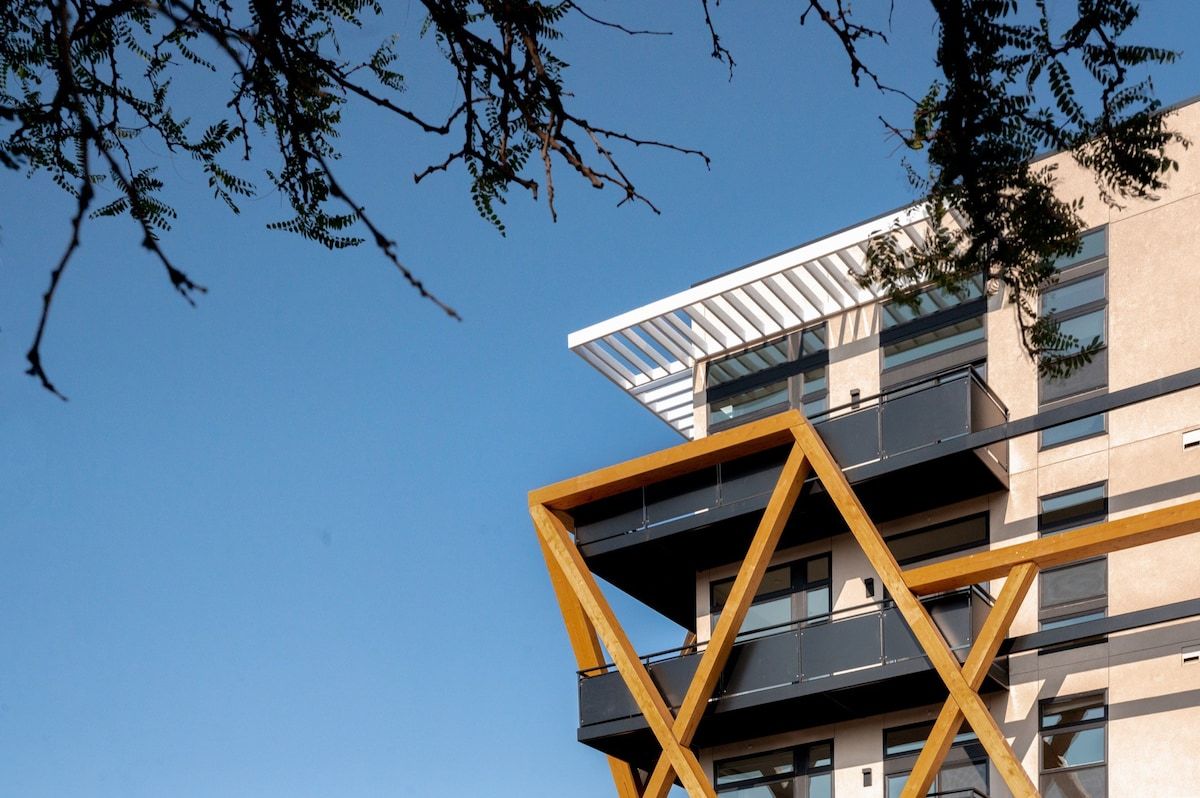 A modern building with a unique architectural design, featuring a prominent yellow and black geometric structure.