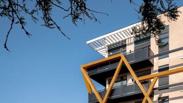 A modern building with a unique architectural design, featuring a prominent yellow and black geometric structure.
