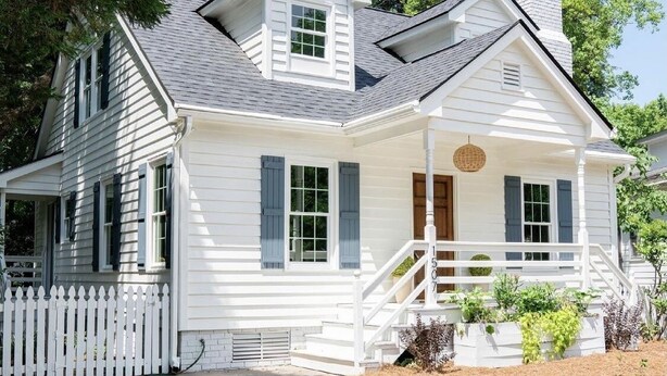 A white two-story house with a porch, a chimney, and a picket fence. - Charleston "Chucktown Cottage" mins to Beach (Mount Pleasant)