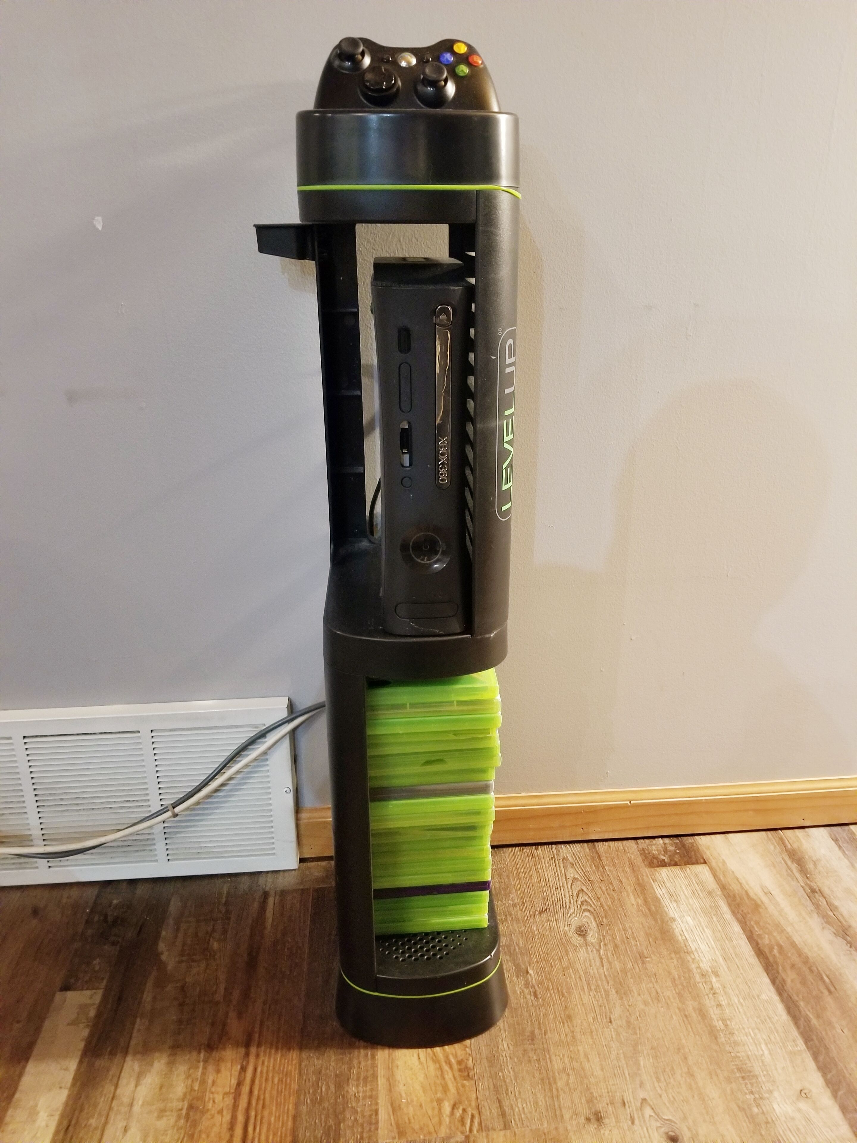 A black and green electric toothbrush with a charging base and a control panel.