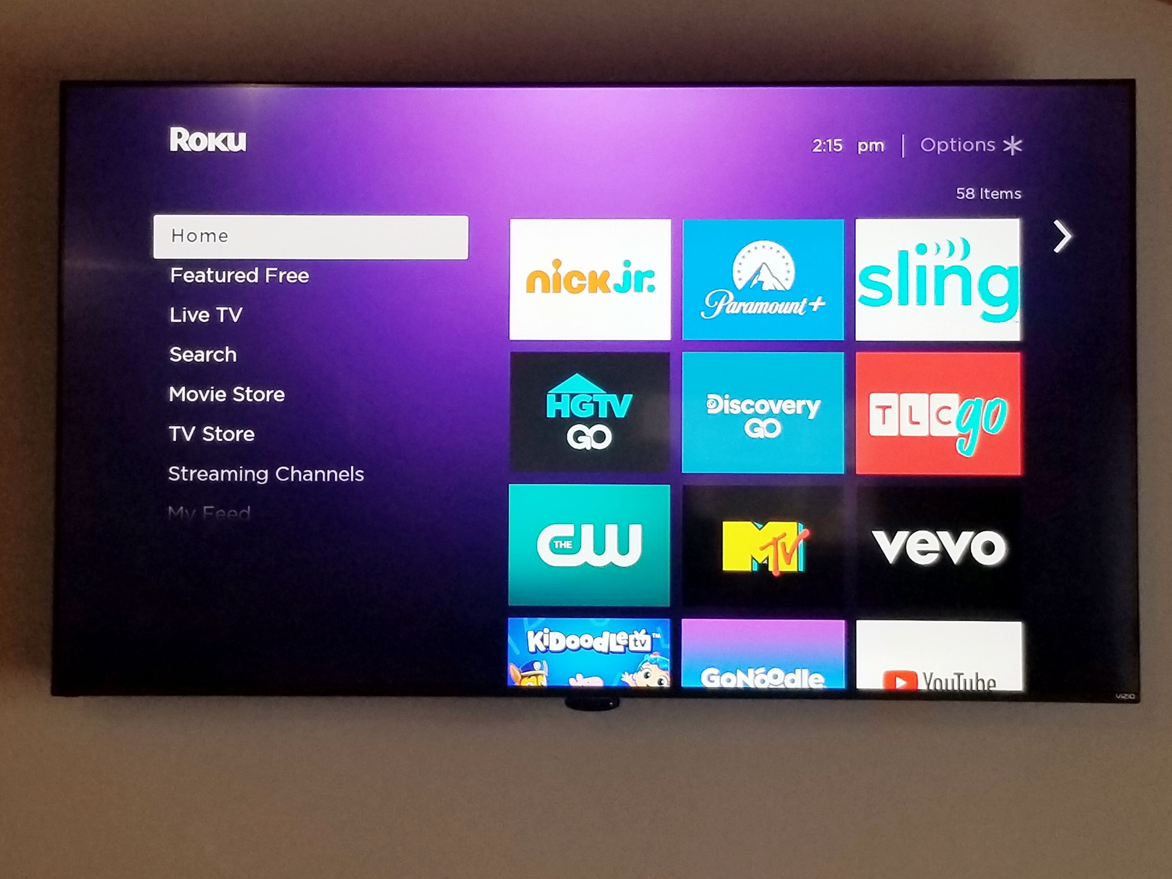 A Roku TV interface with various streaming channel logos.