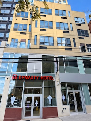 A modern hotel building with a prominent 'Dynasty Hotel' sign. - Dynasty Hotel and Suites New York LaGuardia Hotel (Flushing)