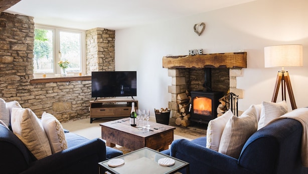 A cozy living room with a stone fireplace, a television, and comfortable seating. - Field View - sleeps 5 guests  in 3 bedrooms (Tarlton)