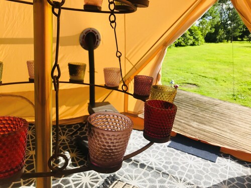 Eclipse, a furnished canvas bell tent in field and woodland surroundings