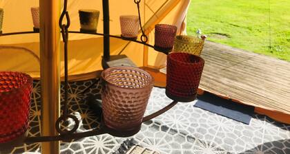 Eclipse, a furnished canvas bell tent in field and woodland surroundings