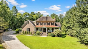 Set amidst a serene and lawn, this charming home offers a peaceful retreat.