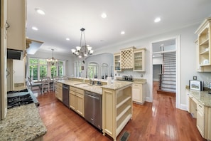 Enjoy cooking in this well-equipped kitchen with a central island, dishwasher, and stainless steel range hood.