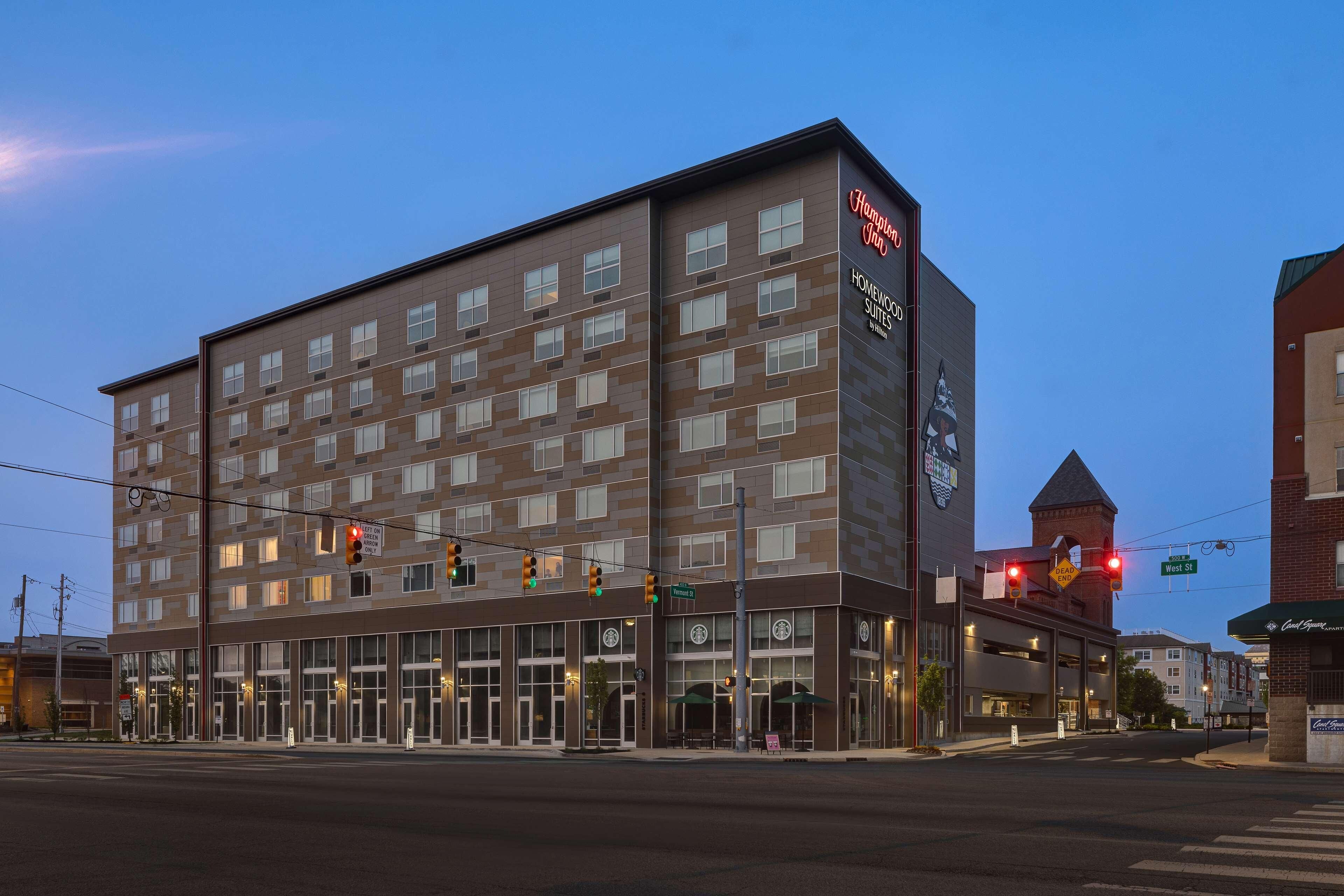 A modern hotel with multiple floors and a prominent sign for Hampton Inn.