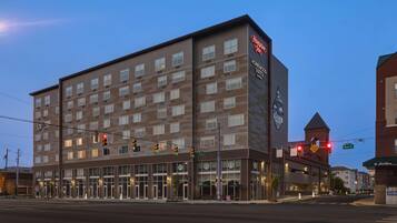 A modern hotel with multiple floors and a prominent sign for Hampton Inn.