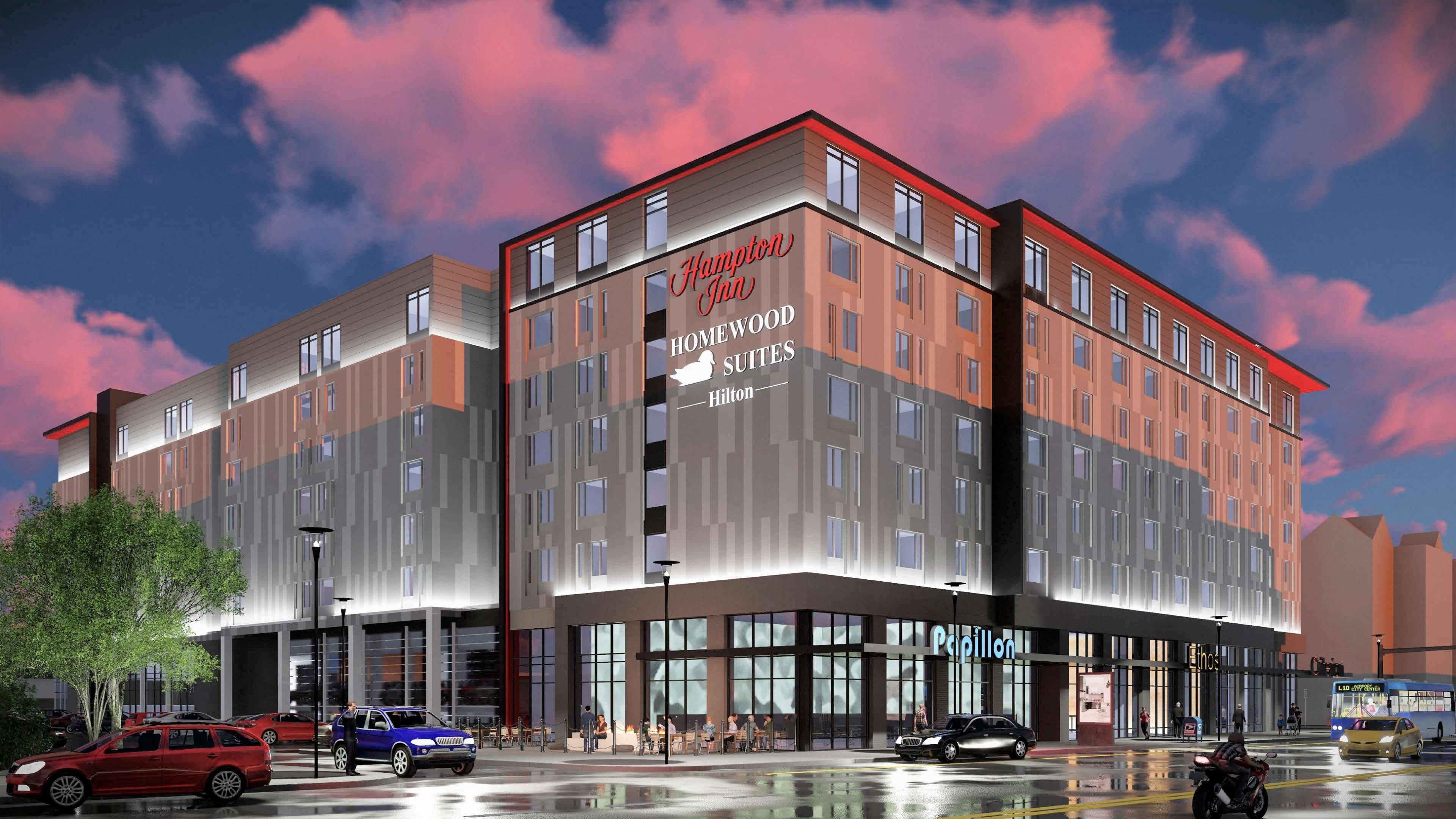 Un hotel moderno con un letrero destacado de Hampton Homewood Suites.
