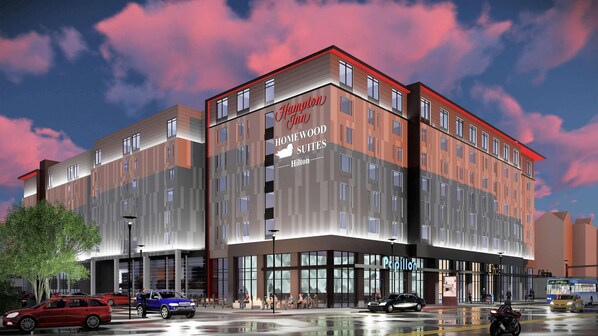 Un hôtel moderne avec une enseigne bien visible indiquant « Hampton Homewood Suites ».
