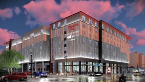 Un hôtel moderne avec une enseigne bien visible indiquant « Hampton Homewood Suites ».