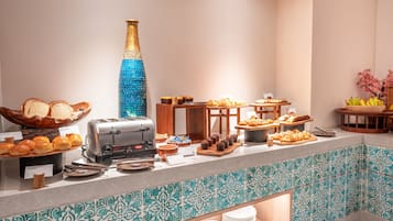 A buffet with various food items, a toaster, and a decorative vase.