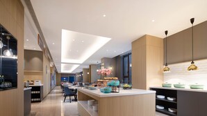 A modern kitchen with a central island, built-in appliances, and pendant lighting. - Holiday Inn Express Xi'an High-tech South by IHG (Xi'an)