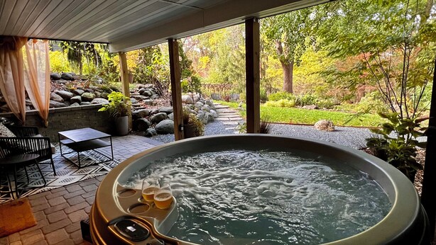 Ein Whirlpool mit Blick auf Garten und Terrasse.