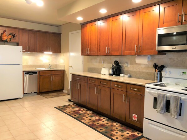 Enjoy cooking in this fully equipped kitchen with a refrigerator, dishwasher, microwave, and stove.