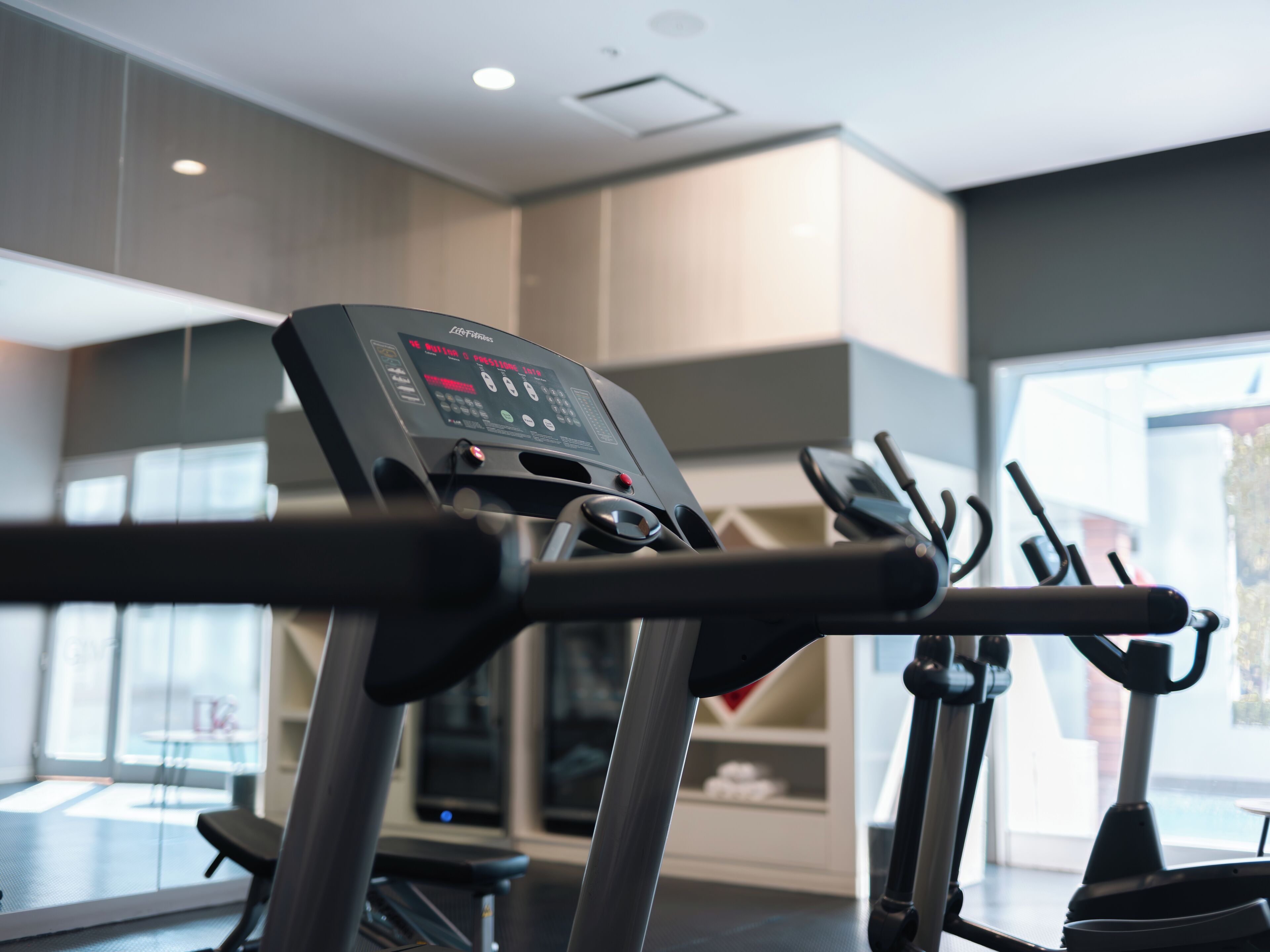 A modern gym with treadmills and exercise equipment.