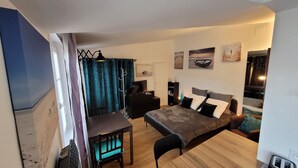 Une chambre à coucher moderne avec un lit, des tables de chevet, un bureau et une chaise.