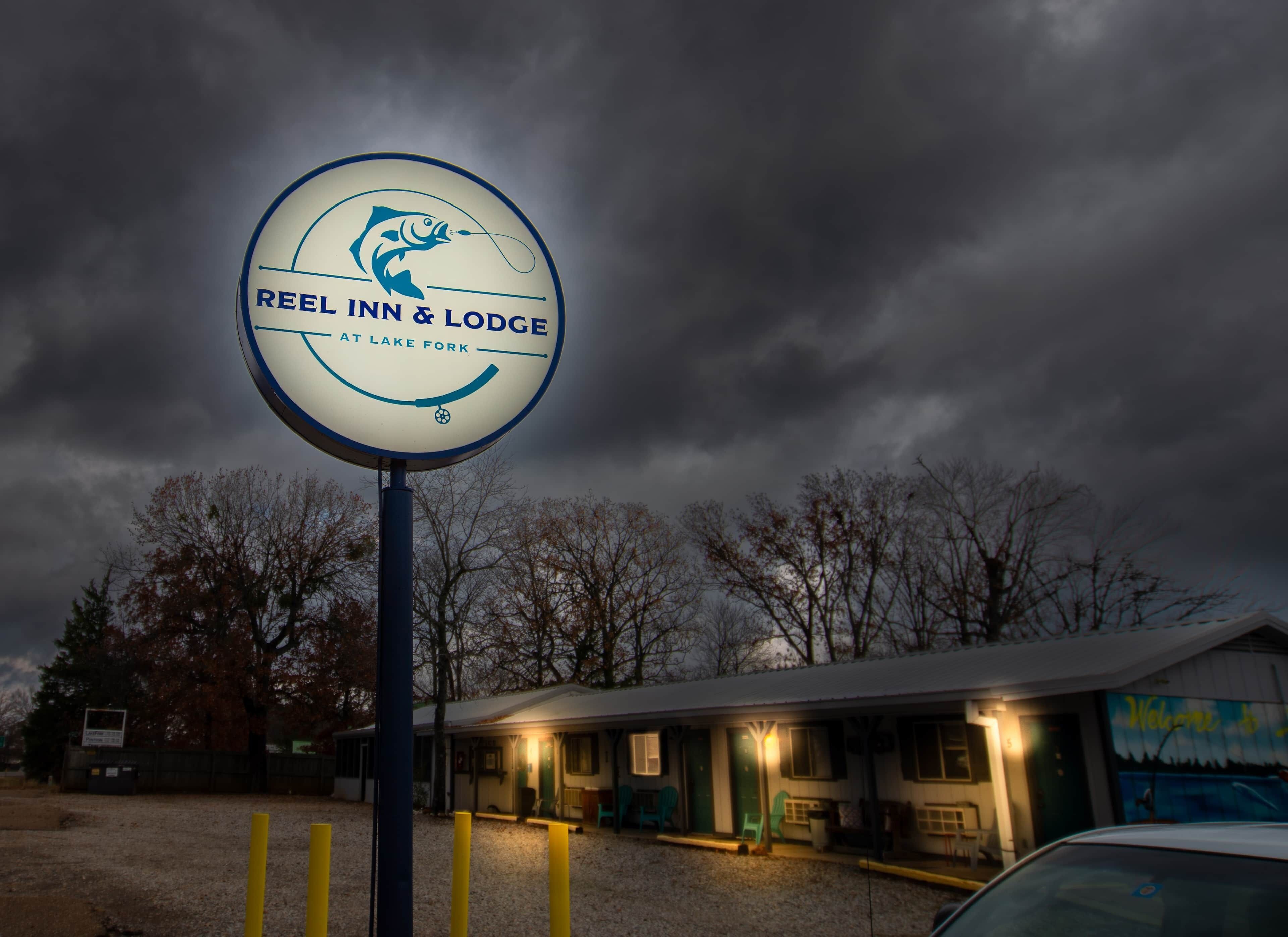 A sign for Reel Inn & Lodge at Lake Fork.