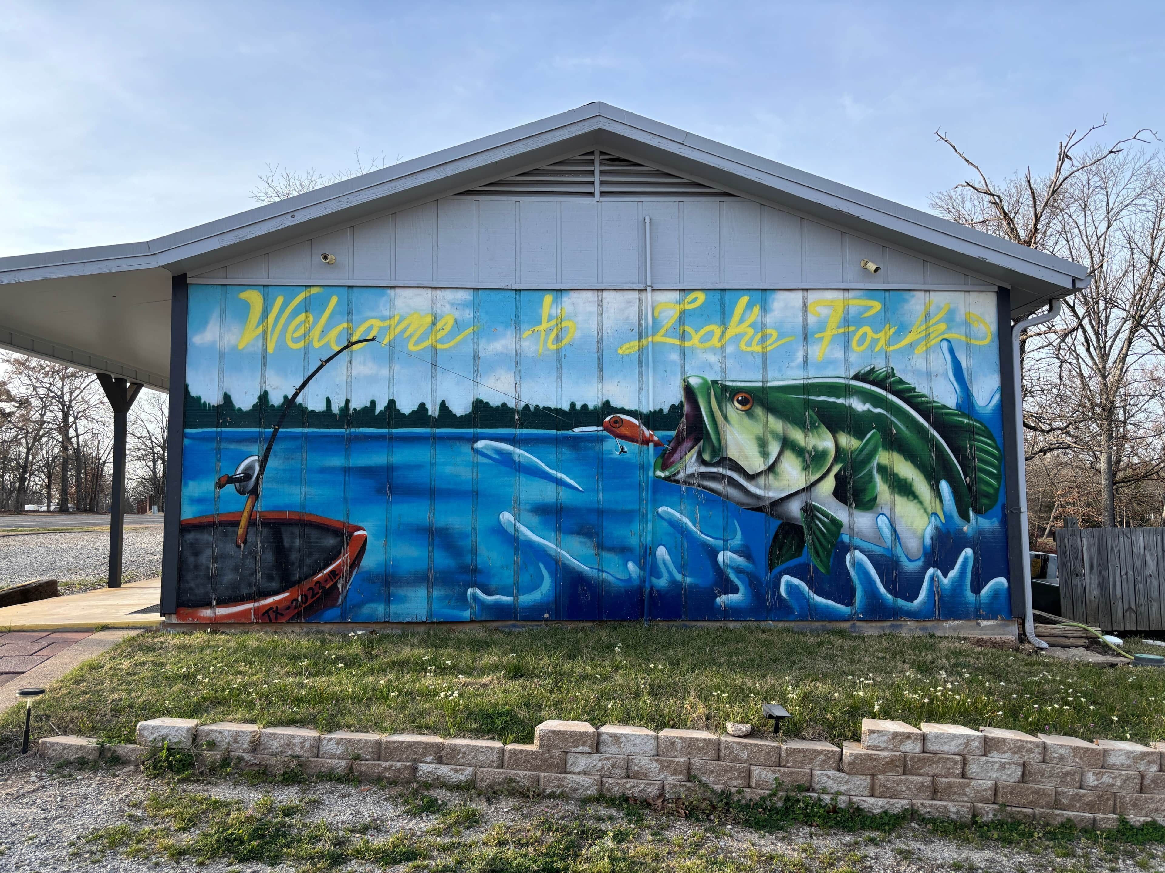 A mural on a building with the text "Welcome to Lake Tahoe" and a fishing scene.
