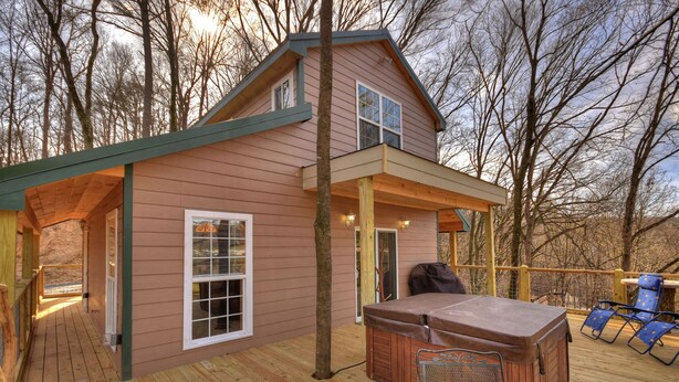 A two-story house with a deck, a hot tub, and outdoor seating. - Treehouse Ellijay Star5vacations (Ellijay)