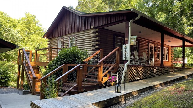 A wooden cabin with a porch, wooden stairs, and a small deck. - Rustic Cabin in the Woods Star5vacations (Black Mountain)