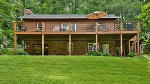 A two-story log cabin with a balcony, a covered patio, and a brick exterior. - Rustic Cabin in the Woods Star5vacations (Black Mountain)