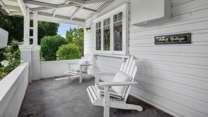 A covered porch with white Adirondack chairs and a sign reading 'Bindi Cottage.' - Bindi Cottage | Classic Charm, Short Stroll to CBD (Orange)