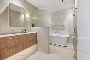 Bathtub, hair dryer, towels, shampoo