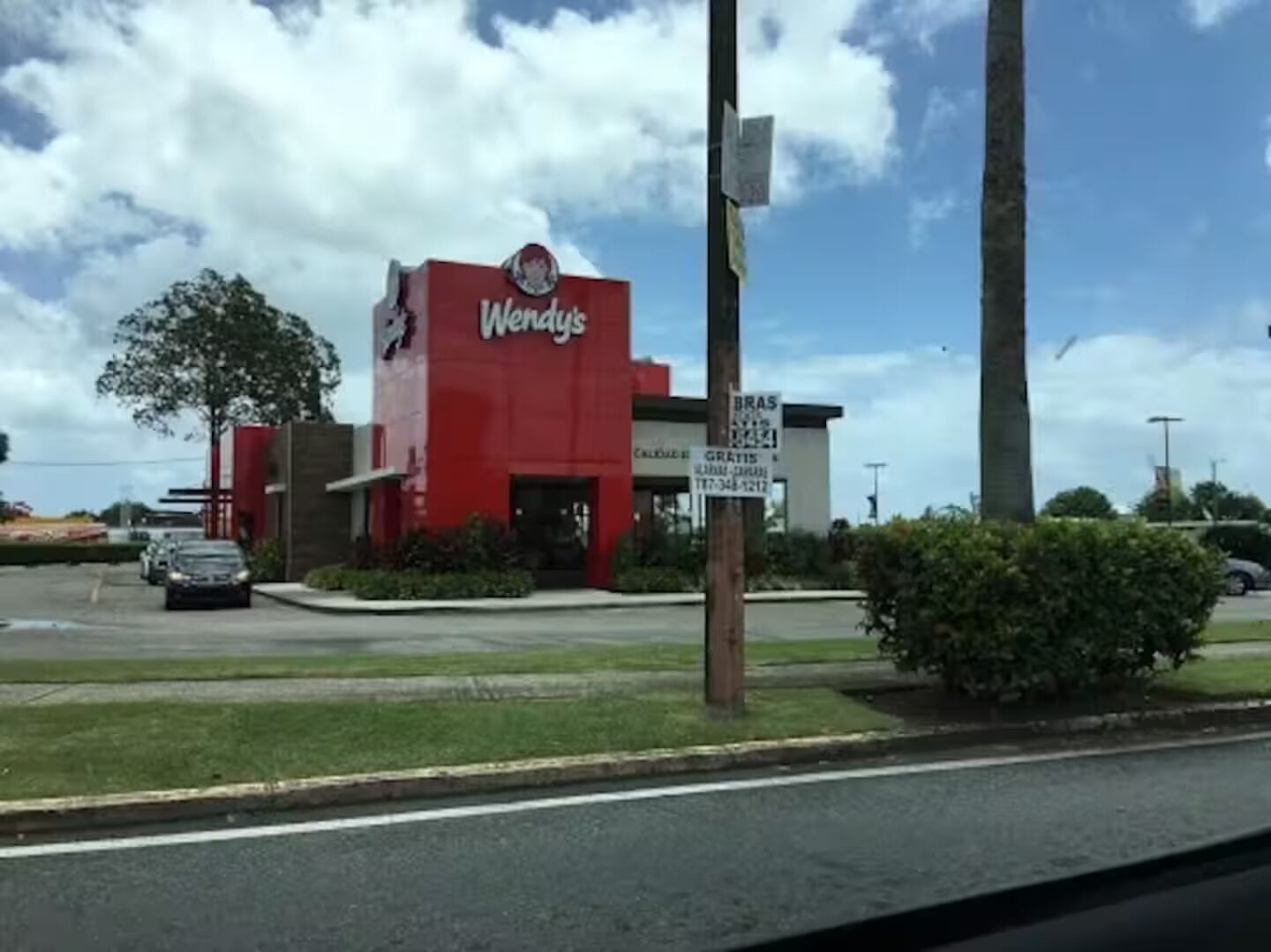 A Wendy's restaurant with a red exterior and a visible drive-thru.