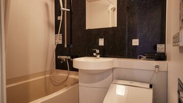 A modern bathroom with a bathtub, a sink, and a toilet.