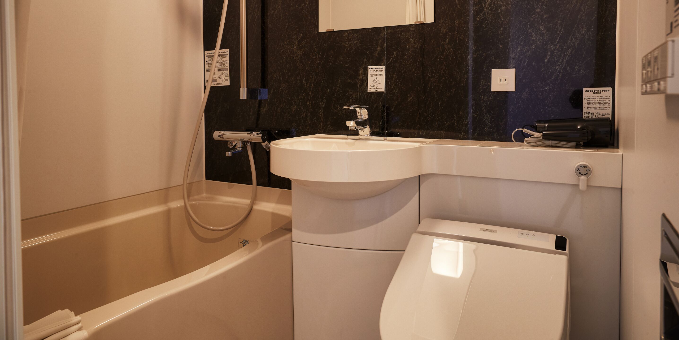 A modern bathroom with a bathtub, a sink, and a toilet.