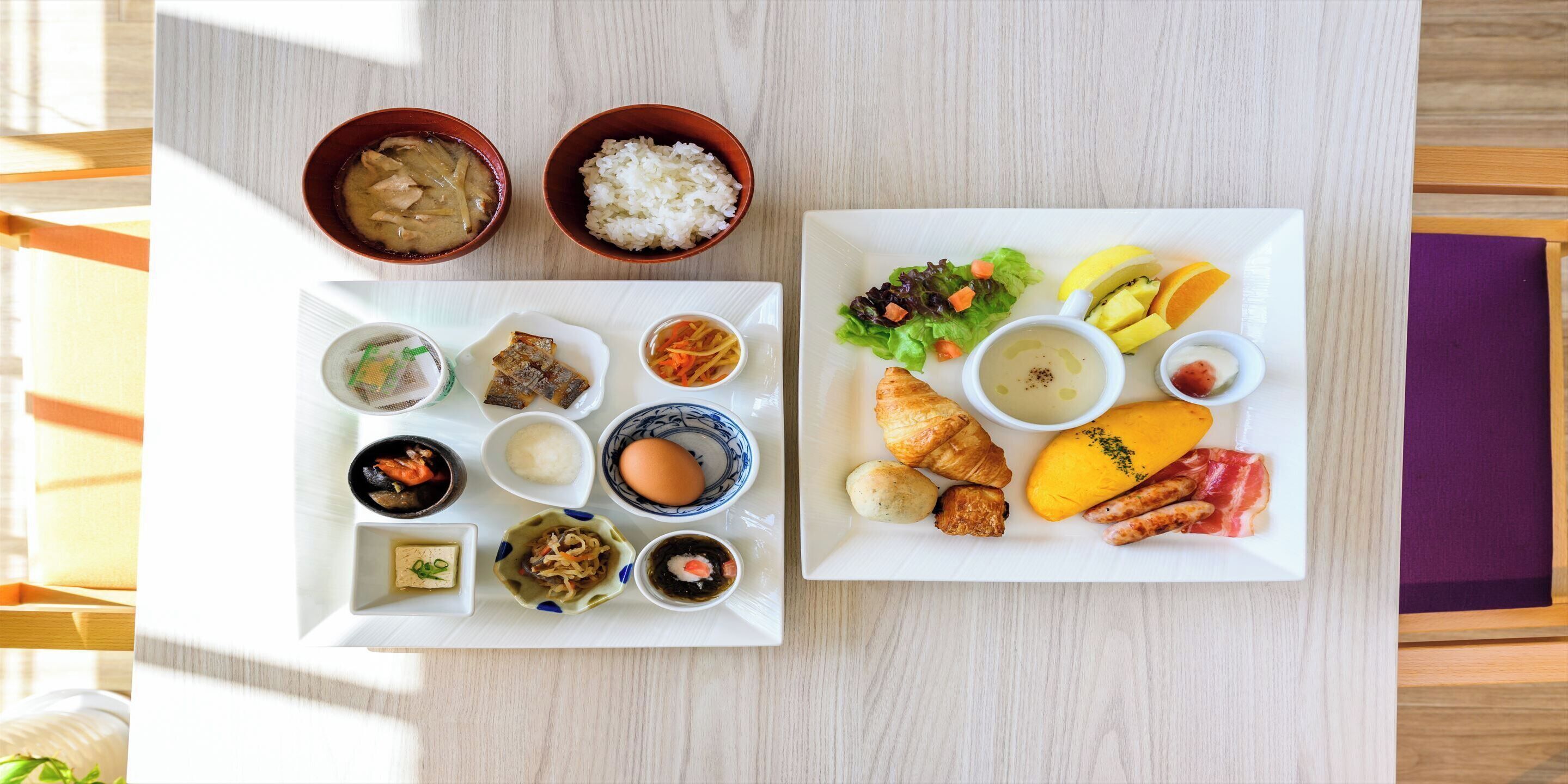 A table with various dishes including rice, soup, and vegetables.