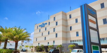 A multi-story hotel with a sign reading "The Grand Hotel Chonwon".