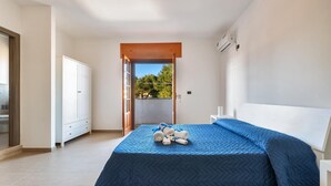 A bedroom with a bed, a wardrobe, and a view of the outdoors. - 1786 B&B Joy Home - Camera 2 (Maruggio)