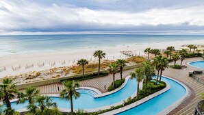 A resort with a pool, beach, and ocean view.