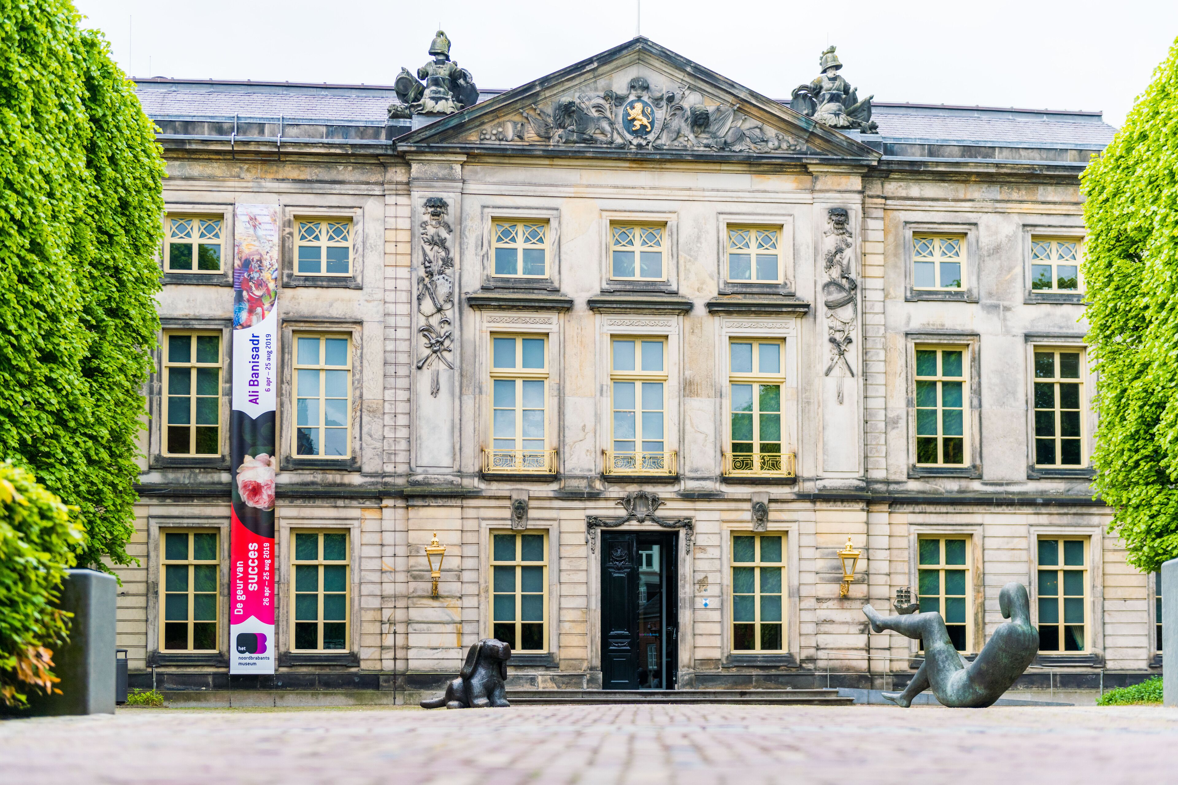 A historic building with a symmetrical facade, large windows, and a central entrance.