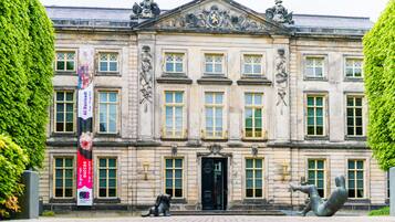 A historic building with a symmetrical facade, large windows, and a central entrance.