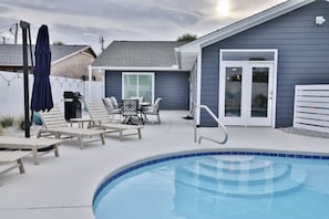 Relax by the pool with comfortable lounge chairs and a shaded area.