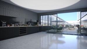 A modern hotel lobby with a sleek black reception desk, a coffee station, and a seating area with umbrellas. - Hotel La Tour (Milton Keynes)