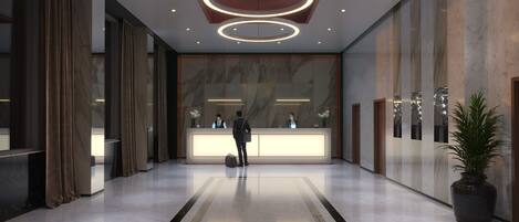A modern hotel lobby with a reception desk, marble walls, and a large potted plant.