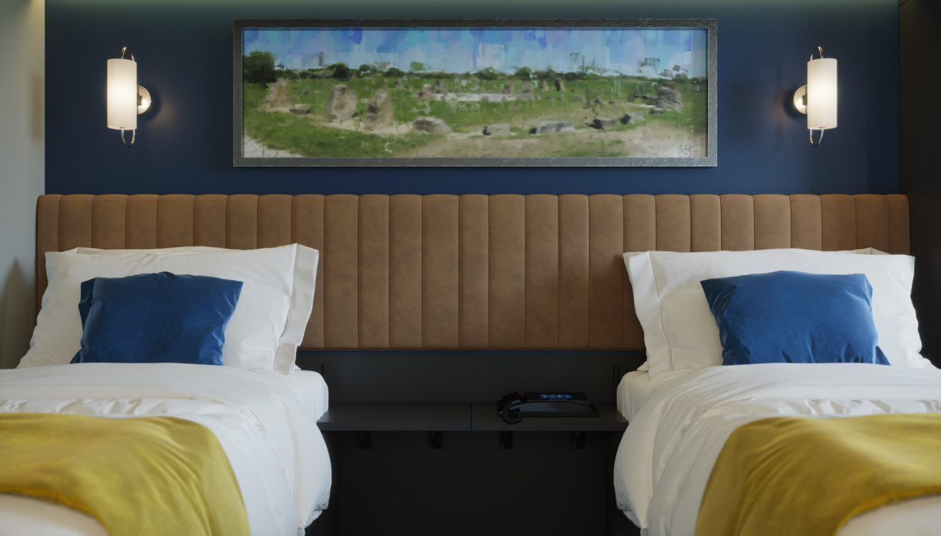 A hotel room with two beds, a headboard, a painting above the beds, and two wall sconces.