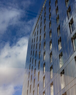 A modern building with a grid of windows and a reflective facade.