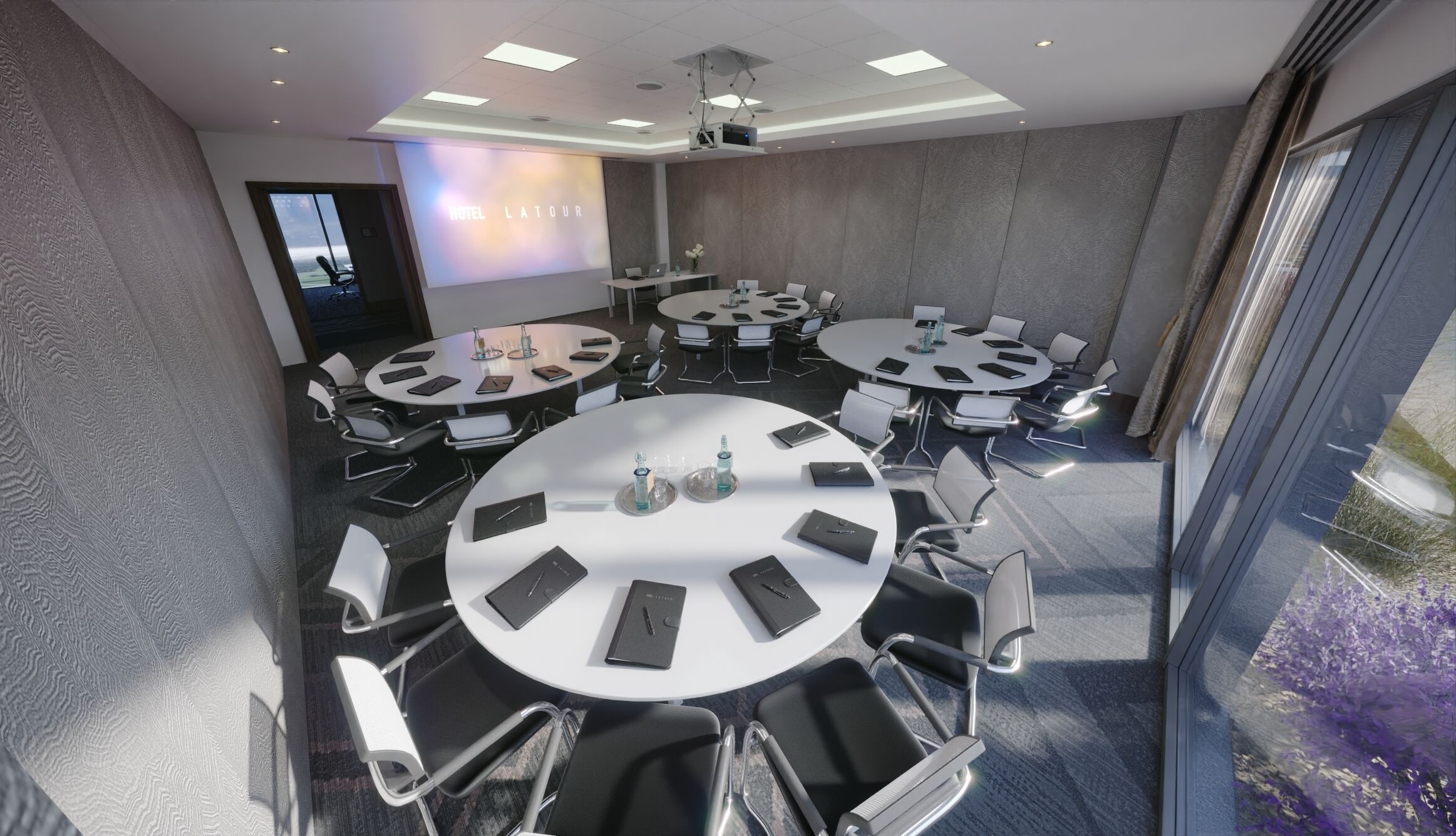 A modern conference room with multiple round tables, each equipped with laptops, notebooks, and pens.