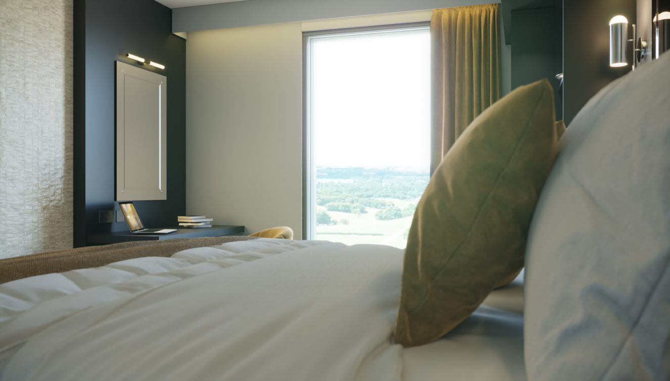 A hotel room with a large bed, a bedside table with a lamp, a mirror, and a view of the outdoors.